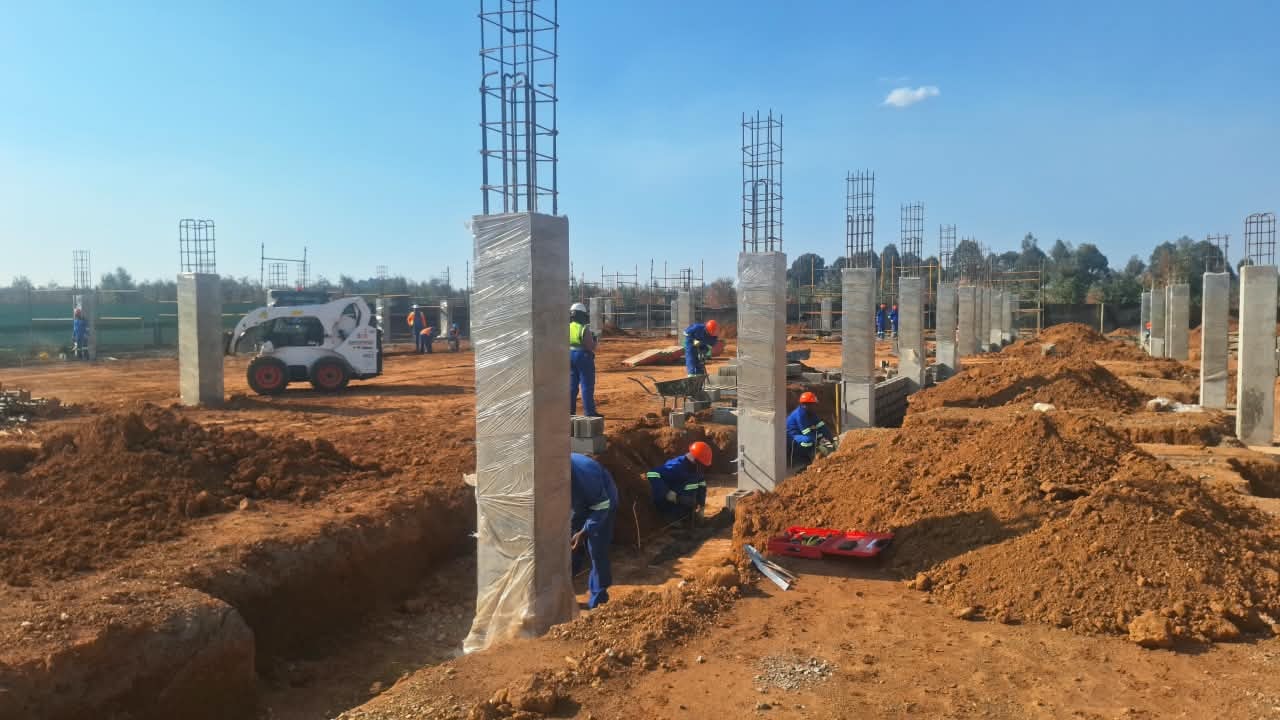 Masonry teams and plant working between column rows at Three Fountains Shopping Centre, September 2026
